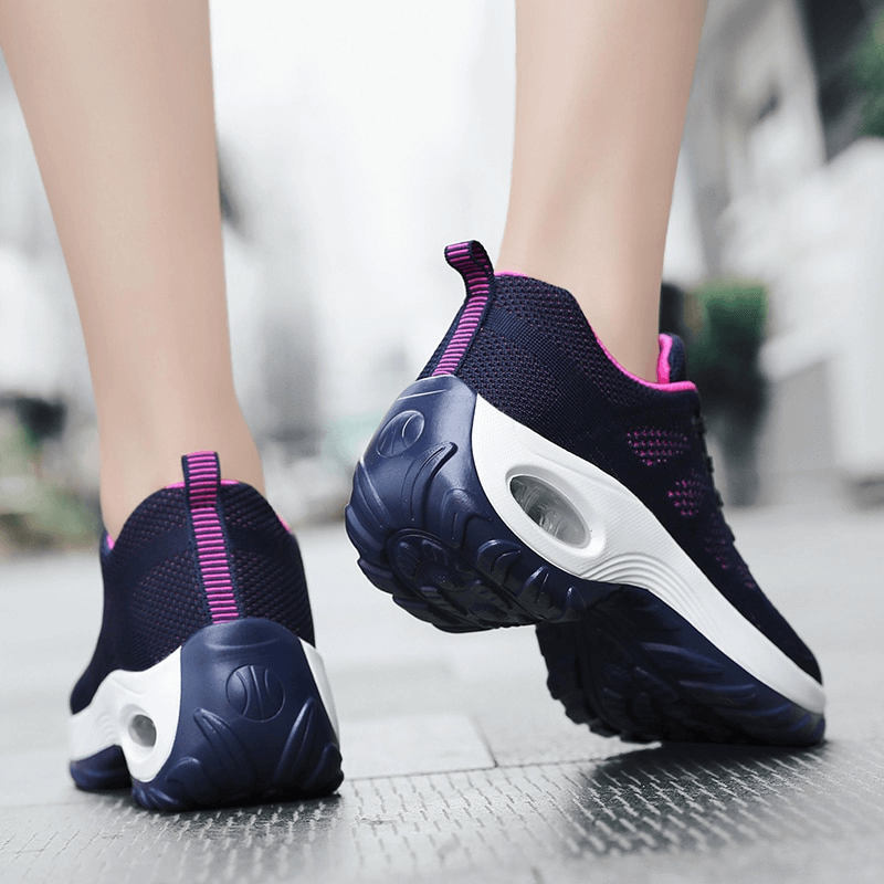 Woman walking in stylish breathable flexible women's sneakers SF0775 with mesh air upper, cushioning EVA insole, and non-slip sole.